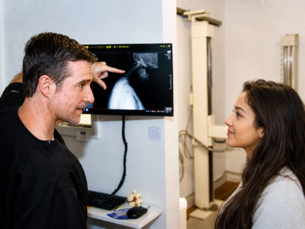Dr. Richard Collin explaining X-rays during a patient visit