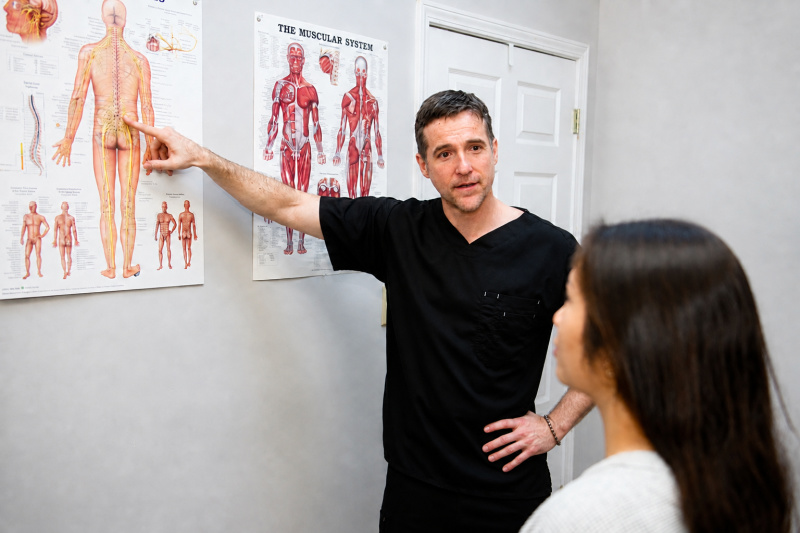 Dr. Richard Collin explaining examination findings to a patient