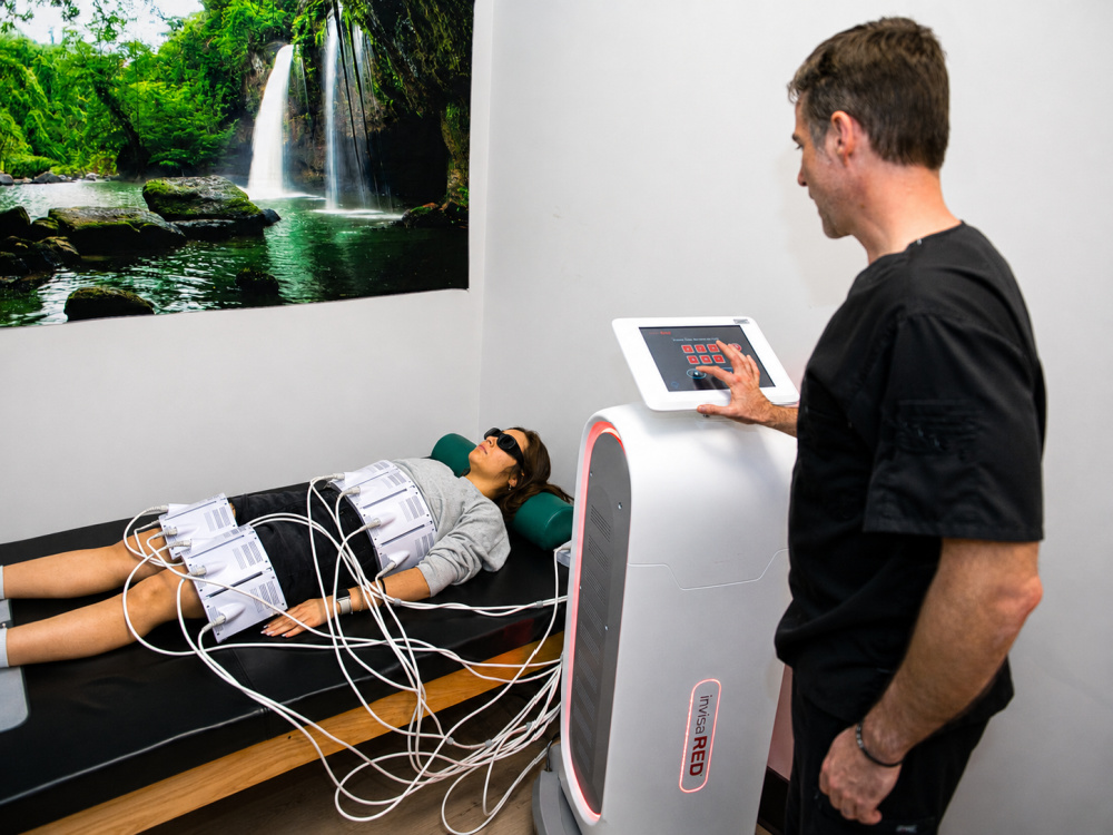 Invisa-RED equipment being used during an office session at Collin Chiropractic